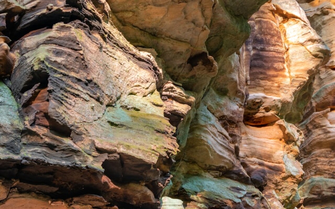 Weathered, layered rock outcrop — the field lithology behind DepoDart's prospectivity models.
